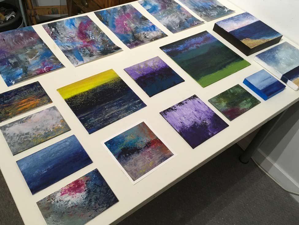 photo of table with lots of small paintings