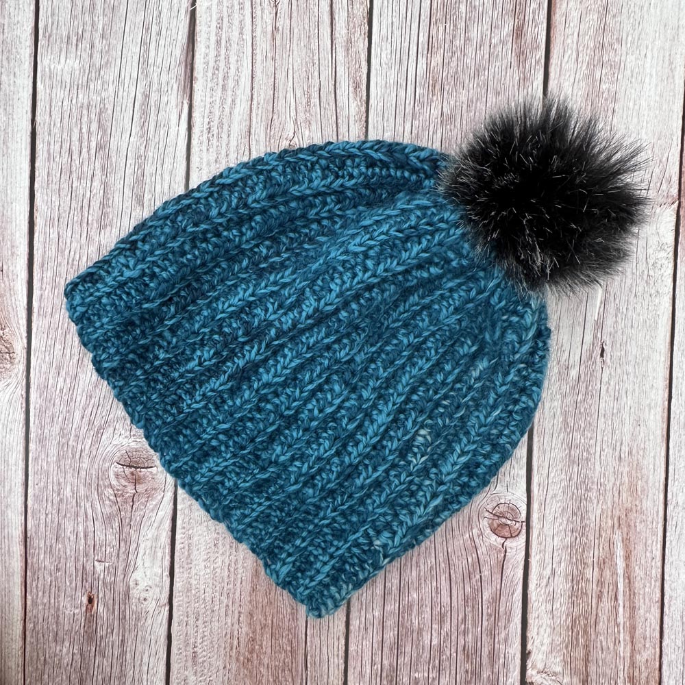 Turquoise ribbed hat made with handspun wool
