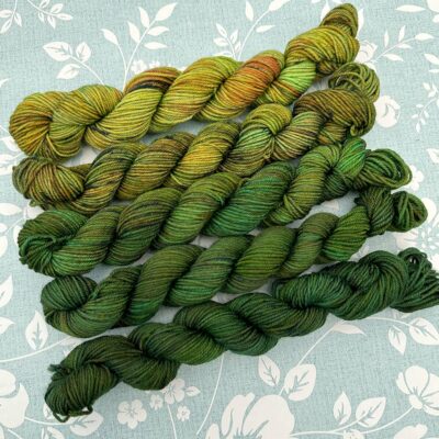 Meadow Walk gradient yarn pack transitioning from bright yellow-green to rich forest green.